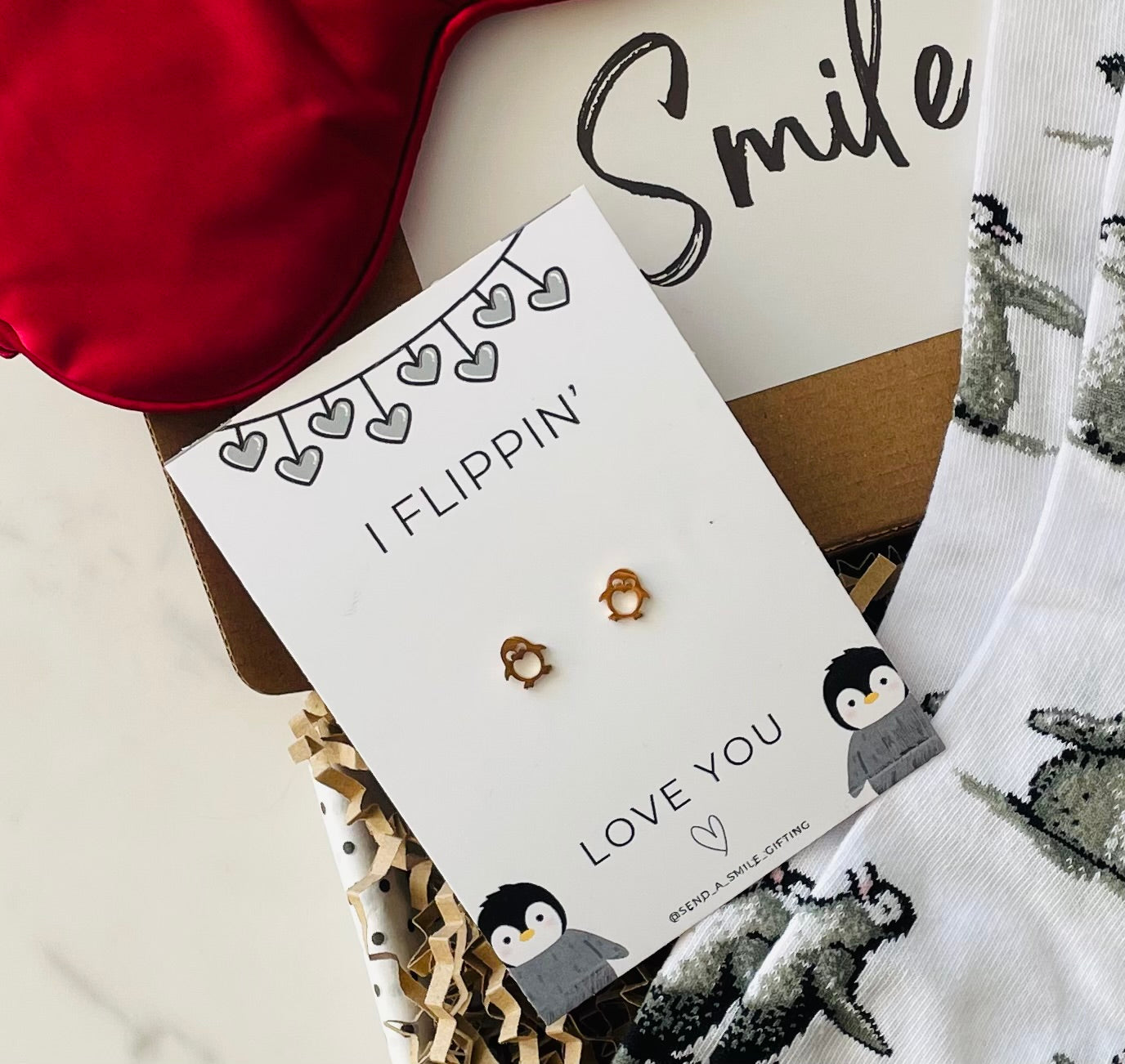 Adorable penguin-themed earrings included in the I Flippin’ Love You gift box, perfect for adding charm to any outfit.