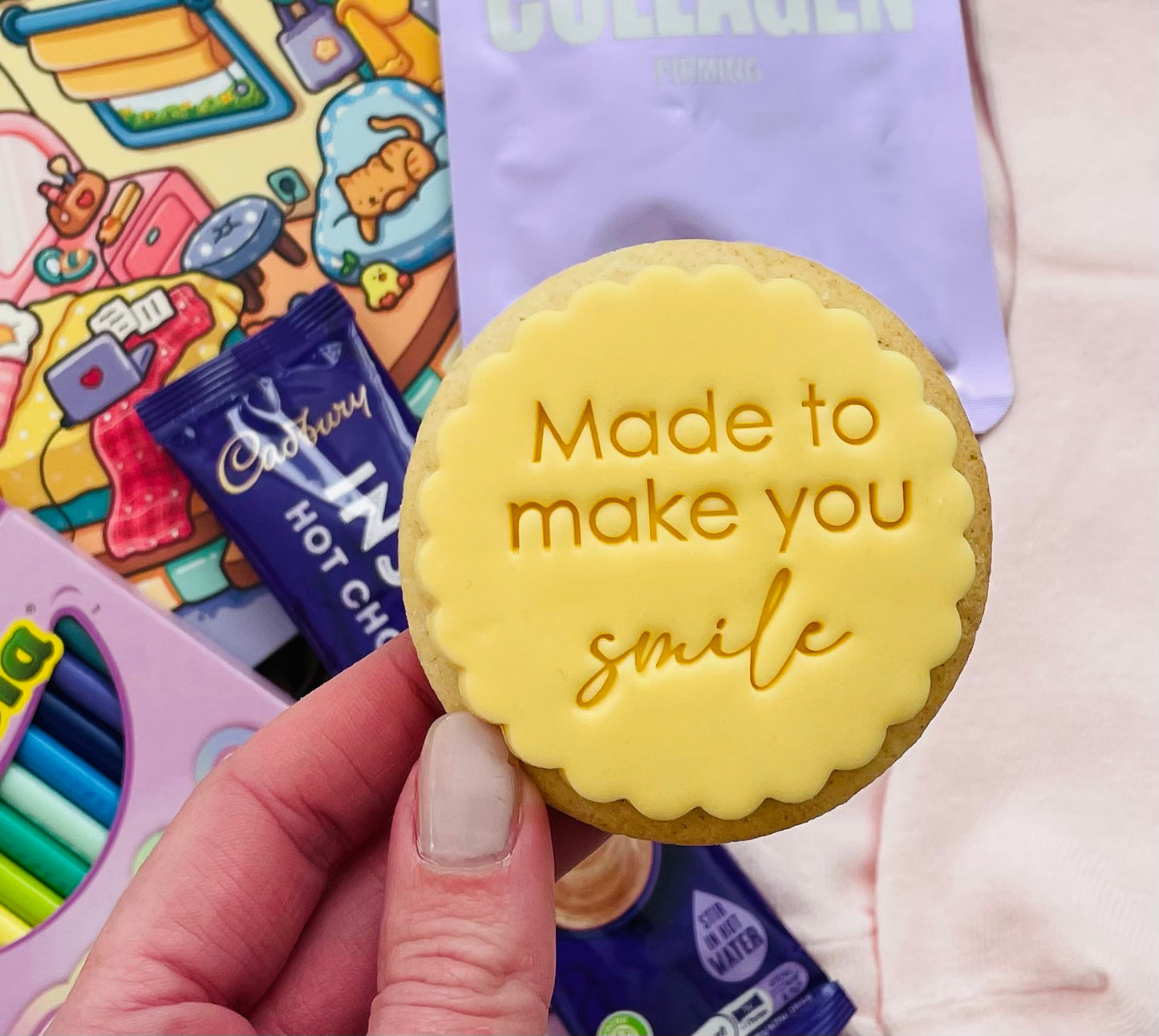 An iced biscuit with the wording 'Made to make you smile'