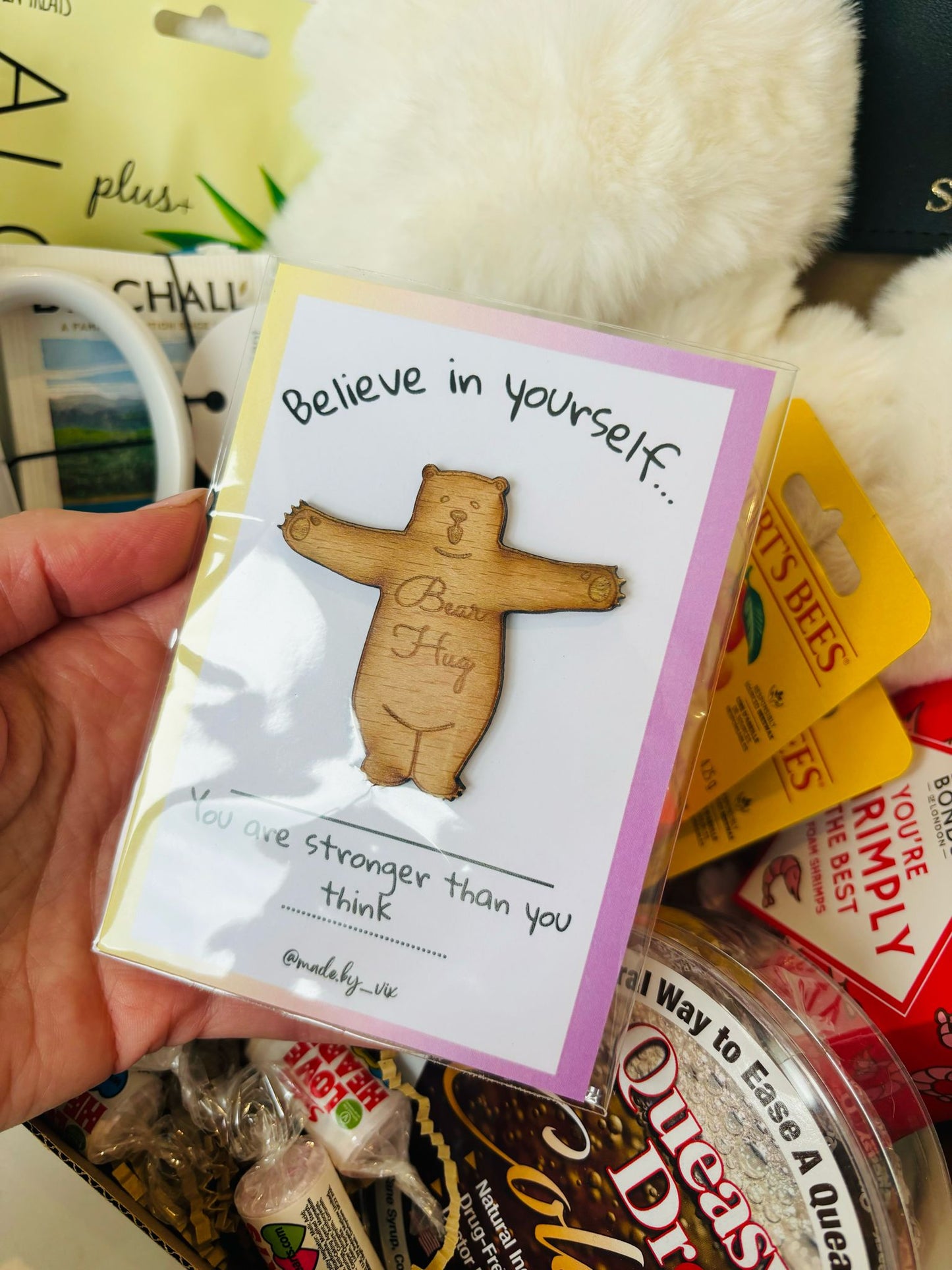 Wooden bear pocket hug on white backing card, with wording, Believe in yourself, you are stronger than you think. 