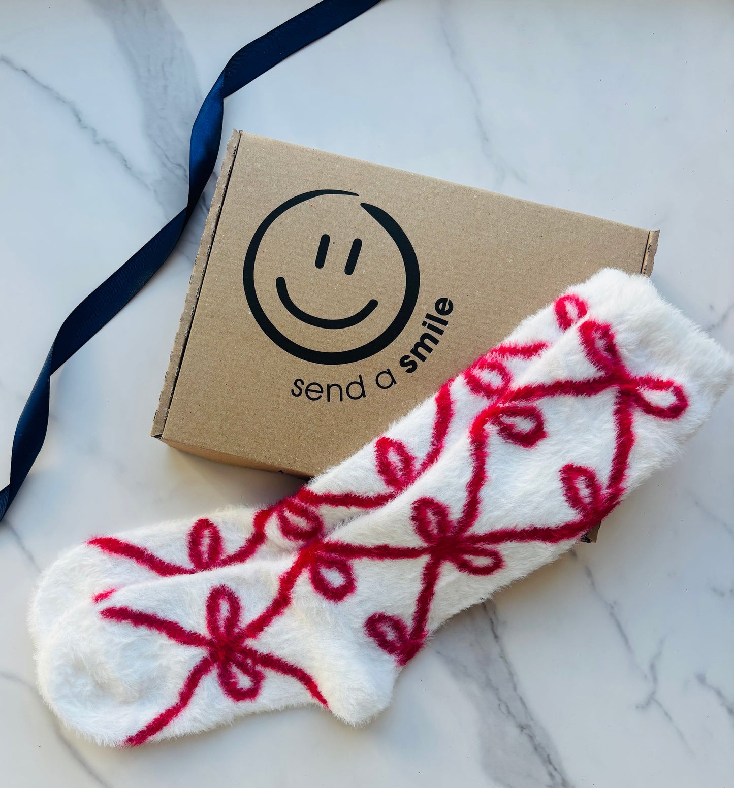 White sock with red bow pattern. Build your own gift box