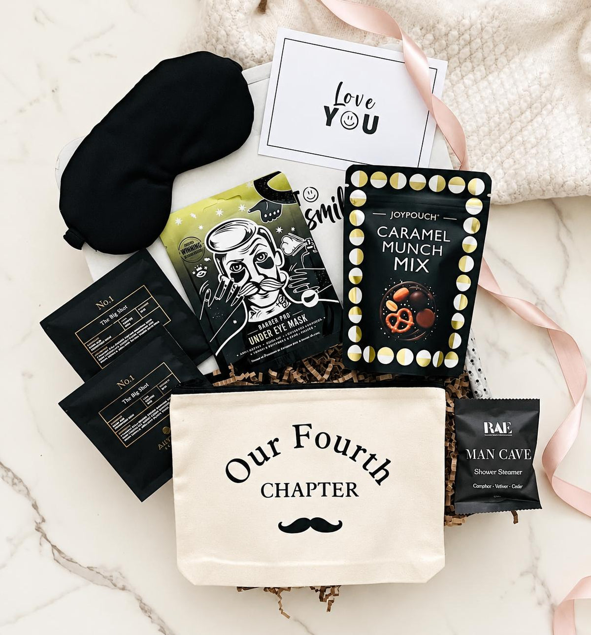 4th wedding anniversary gift box for him with pamper items, treats, a linen wash bag printed with Our Fourth Chapter and a Love You gift card